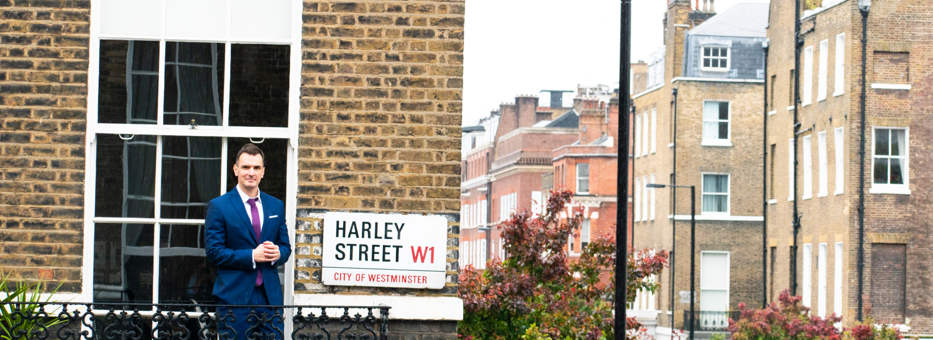 dr thomas stavrakis on a balcony at harley street